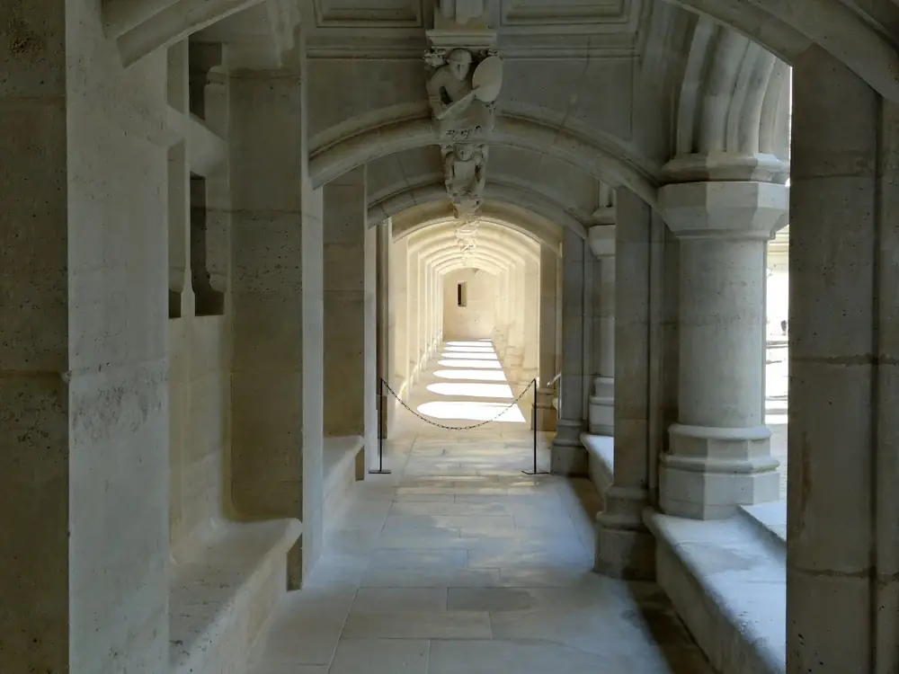 Sunlight falling along a vaulted stone gallery inside Château de Pierrefonds